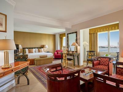 Elegantní hotelový salon s pohodlným sezením a výhledem na moře přes velké okno.