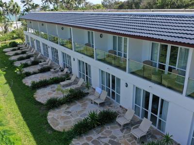 Moderner Hotelbau mit zwei Etagen, Balkonzimmern und mediterranem Garten