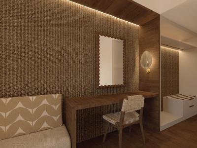 Elegant hotel room area with desk, chair, and indirect lighting on wooden wall panels.