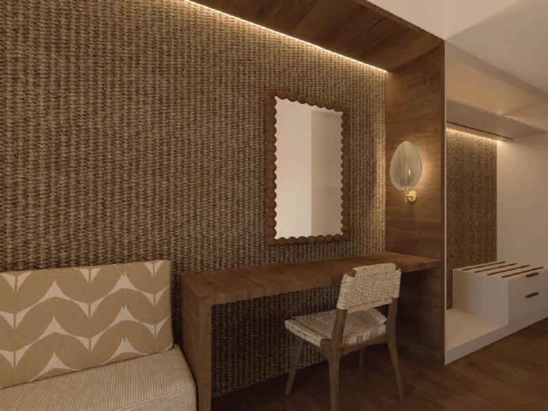 Elegant hotel room area with desk, chair, and indirect lighting on wooden wall panels.