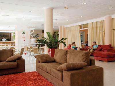 Cozy hotel lounge area with brown sofas and red carpets