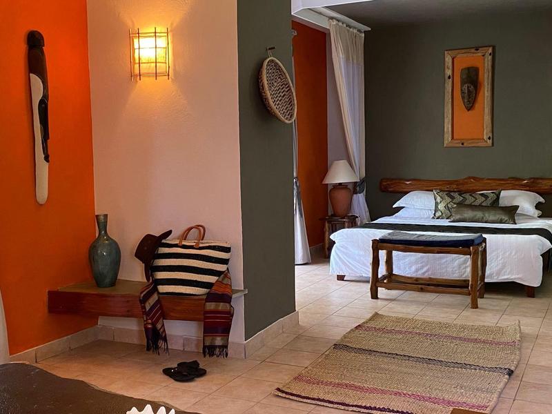 Camera d'hotel accogliente con letto matrimoniale, mobili in legno e atmosfera rilassata.