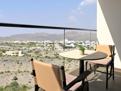 Příjemná hotelová restaurace s moderními židlemi a uměleckou nástěnnou malbou.