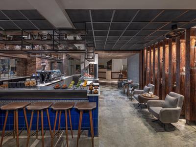 Modernes Hotelbar-Interieur mit Holz- und Ledermöbeln sowie stimmungsvoller Beleuchtung.