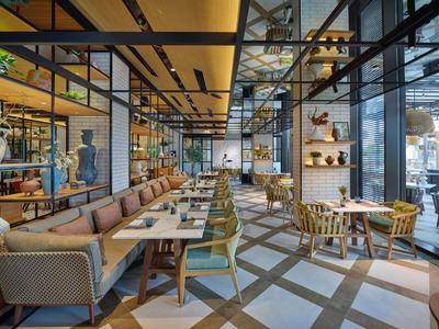 Restaurant moderne avec une longue zone de sièges et de grandes fenêtres.