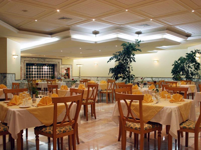 Heller Speisesaal mit eingedeckten Tischen und Holzmöbeln in einem Hotel.