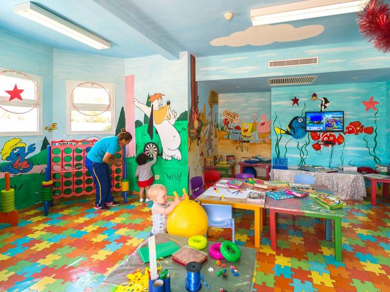 Brightly colored indoor children's play area with sea-themed murals and toys.