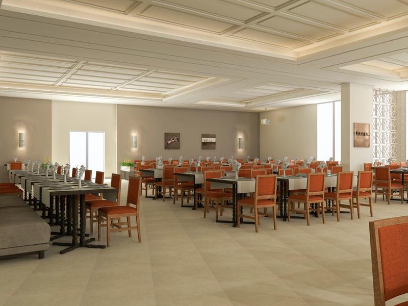 Gran comedor de hotel con mesas y sillas naranjas y grises, luz natural e iluminación cálida