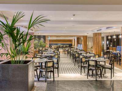 Modern eingerichtetes Hotelzimmer mit Doppelbett, Schreibtisch, Kleiderschrank und beruhigenden Farben.