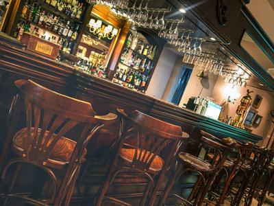 Gemütliche Bar mit Holzmöbeln und einer gut bestückten Getränketheke.