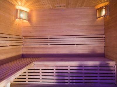 Interior view of a traditional Finnish sauna with wooden paneling and benches.
