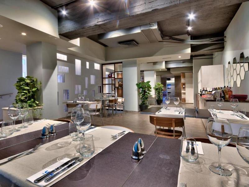 Interior moderno de restaurante con mesas puestas y luz acogedora