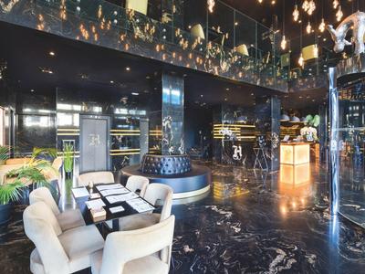 Elegant hotel lobby with modern seating and glossy marble flooring.