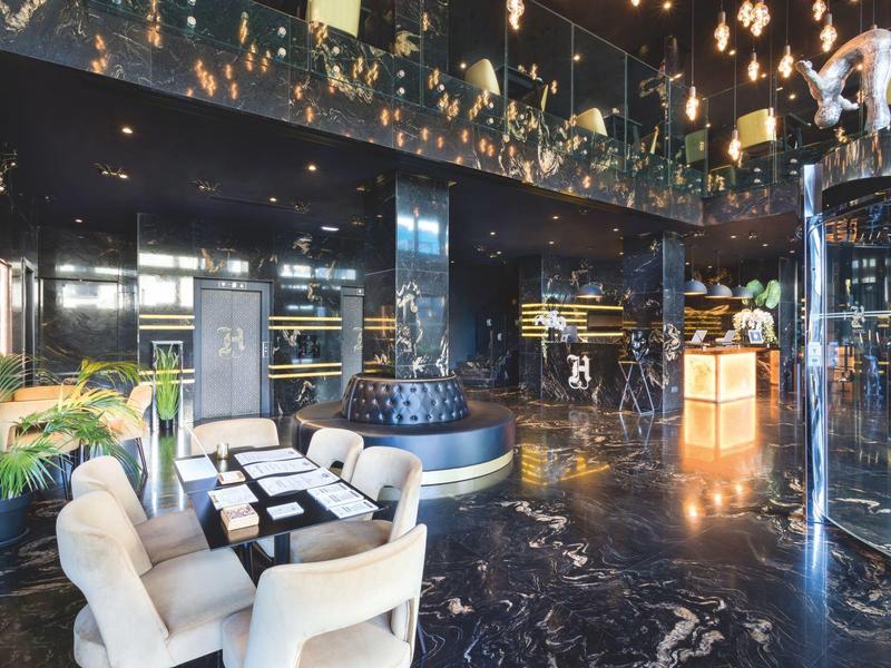Elegant hotel lobby with modern seating and glossy marble flooring.
