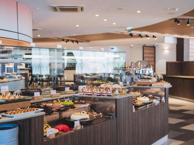 Área de buffet en un restaurante de hotel moderno con varios platos y diseño elegante.