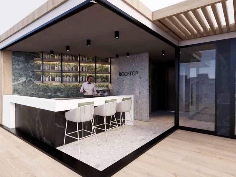 Área exterior moderna con barra y sillas blancas bajo un pabellón cubierto.