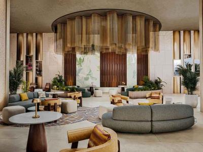 Großer, moderner Hotellobby mit runden Sofas, Holzdetails und Pflanzen in Naturtönen.