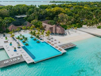 Luxuriöse Strandanlage mit Infinity-Pool, weißen Sandstränden und tropischem Grün.