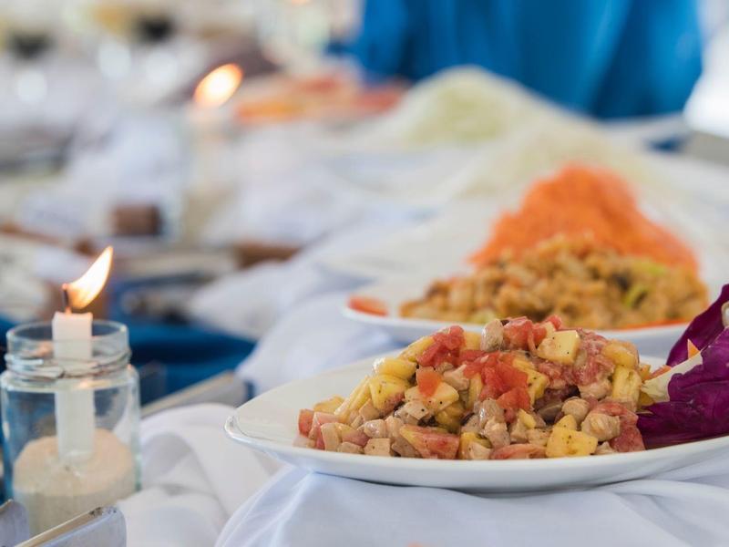 Buffet mit gebratenem Reis und verschiedenen Beilagen auf weißen Tellern.