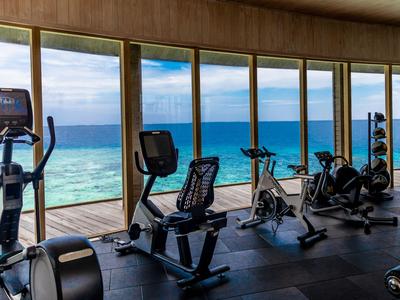 Gym with cardio machines and sea view through large windows