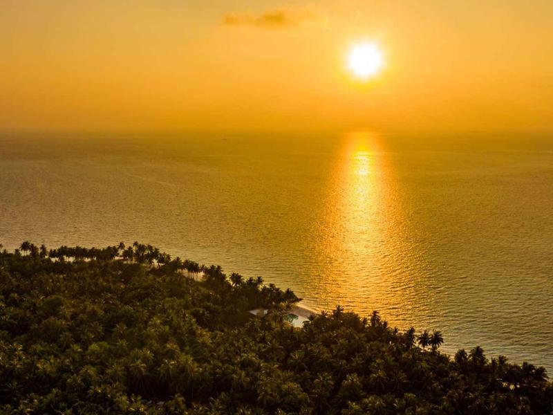 Modern hotel room with large bed and open bathroom area.
