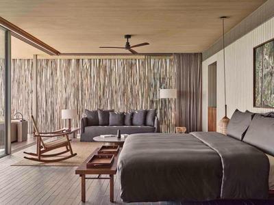 Modern, colorful room with bean bags, chairs, and shelves, ideal for leisure or relaxation.