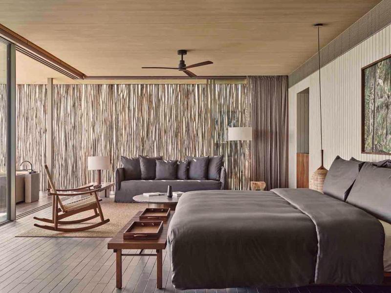 Modern, colorful room with bean bags, chairs, and shelves, ideal for leisure or relaxation.