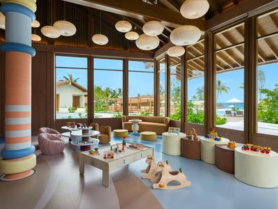 Bright, cozy kids' room with colorful pillars and large windows overlooking the garden