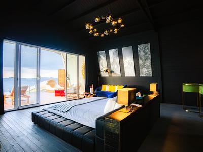 Modern hotel room with large bed and bright view through floor-to-ceiling windows.