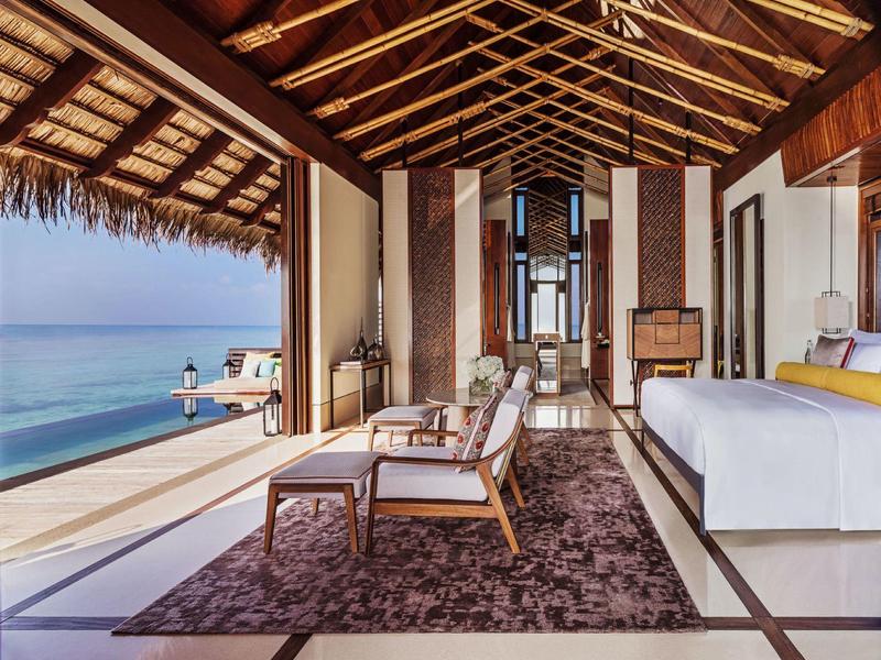 Luxurious villa with ocean view, open living space, and wooden vaulted ceiling.