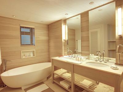 Modernes Hotelbad mit freistehender Badewanne und großem Doppelwaschbecken.