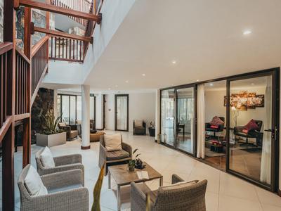 Moderner Hotel-Loungebereich mit Sitzgelegenheiten und Glaswänden zu Konferenzräumen.