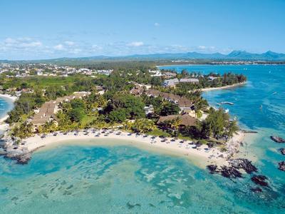 Aerial view of a tropical coastline with sandy beach and clear blue water.