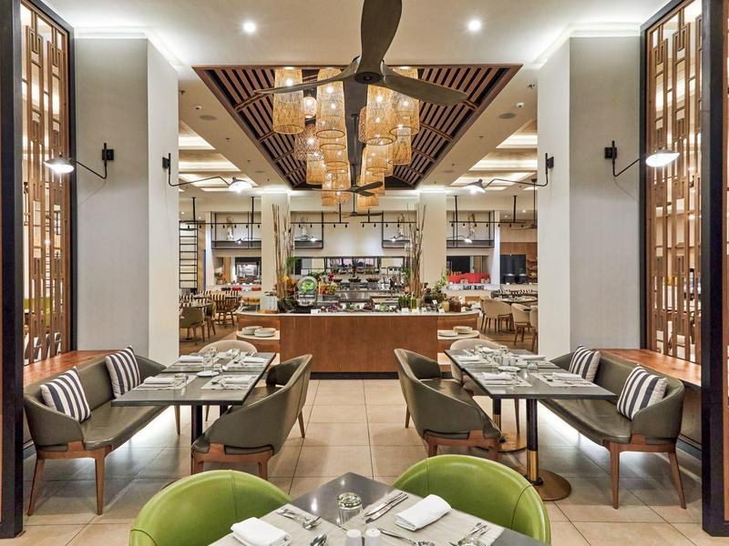 Elegant hotel restaurant area with modern seating and warm ambiance.