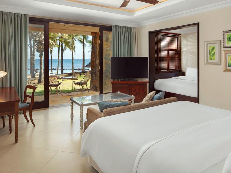 Lichte hotelkamer met tweepersoonsbed, balkon met uitzicht op zee en zithoek