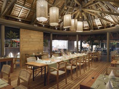 Modernes Restaurant mit Holzverkleidung, großen Lampen und langen, gedeckten Tischen in warmem Licht.