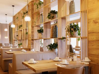 Moderní restaurace s dřevěným nábytkem a rostlinami na otevřených policích.