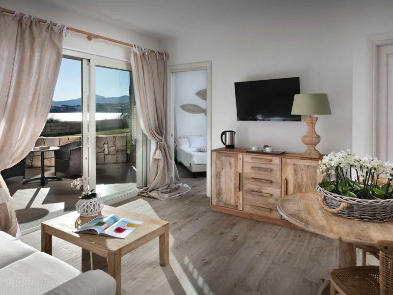 Bright living room with balcony access, wood flooring, and modern furnishings.