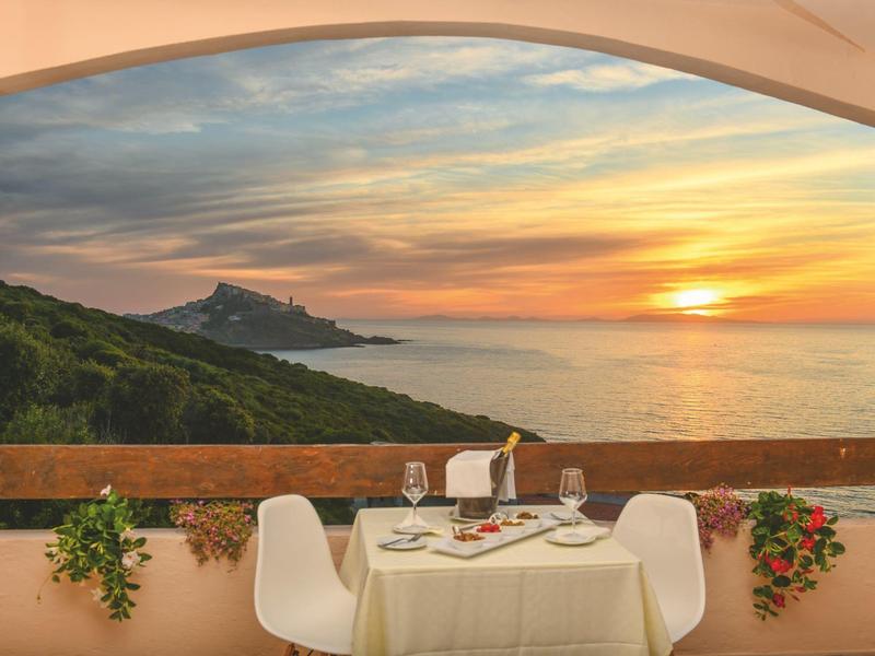 Cena romantica con vista sul mare e tramonto da una terrazza.