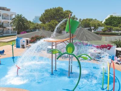 Water playground with colorful play structures and water sprays in a hotel pool area
