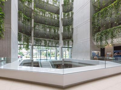 Modern hotel with green interior walls and bright, minimalist design.