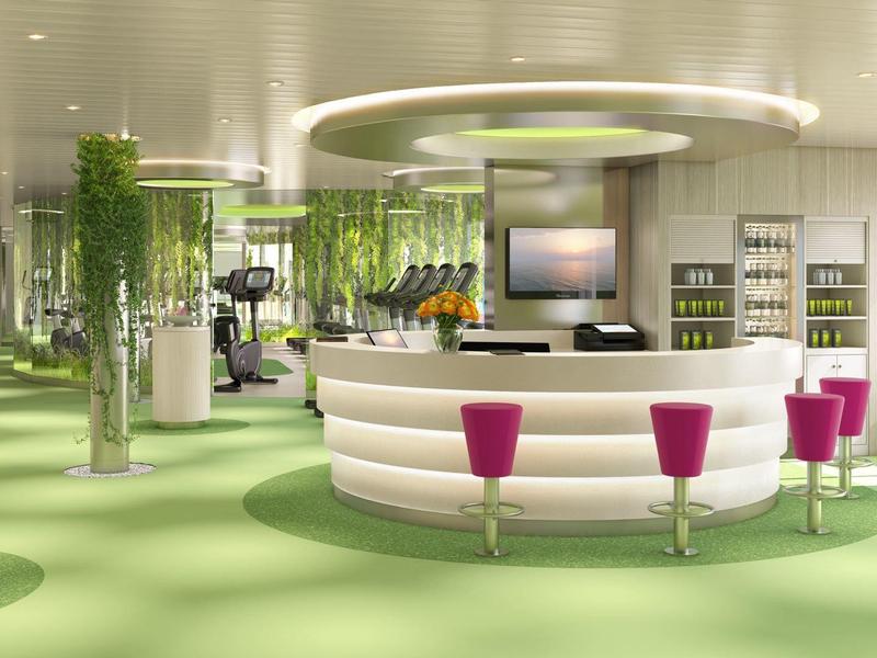 Modern hotel lobby with circular reception desk, green carpet, and magenta chairs.