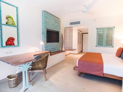 Colorful children's playroom with small tables, cushions, and wall decorations in the hotel.