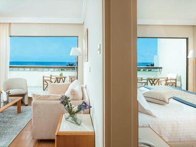 Meerblick von moderner Wohnung mit Wohnzimmer und Schlafzimmer, helle Farben, große Fenster.