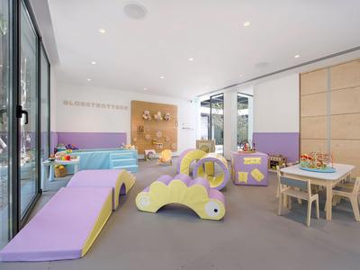 Heller, moderner Kinderbereich mit buntem Spielzeug und Sitzgelegenheiten in einem Hotel.