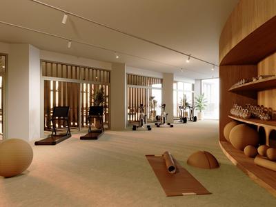 Gimnasio moderno con máquinas de ejercicio y colchonetas de yoga en una habitación luminosa.