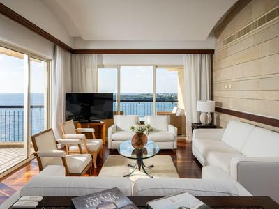 Modern eingerichtetes Wohnzimmer mit Meerblick in einem Hotelzimmer.