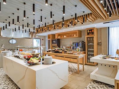 Modern breakfast room with buffet and wooden elements in a hotel.