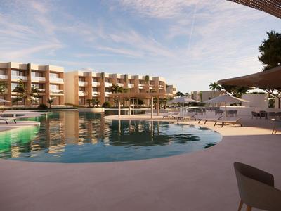 Piscina moderna de hotel con tumbonas y palmeras al atardecer.