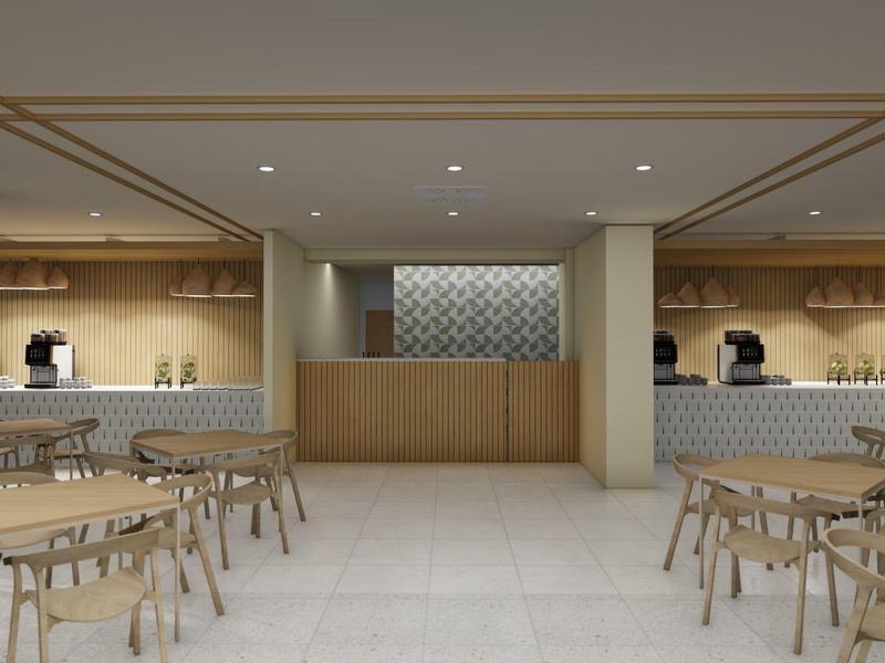 Sala colazione moderna con tavoli in legno, sedie e macchine da caffè a muro.